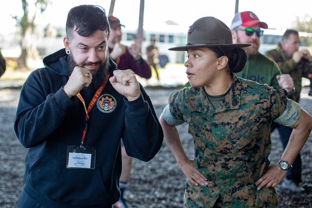 A Marine Drill Instructor motivates an educator during a workshop event.